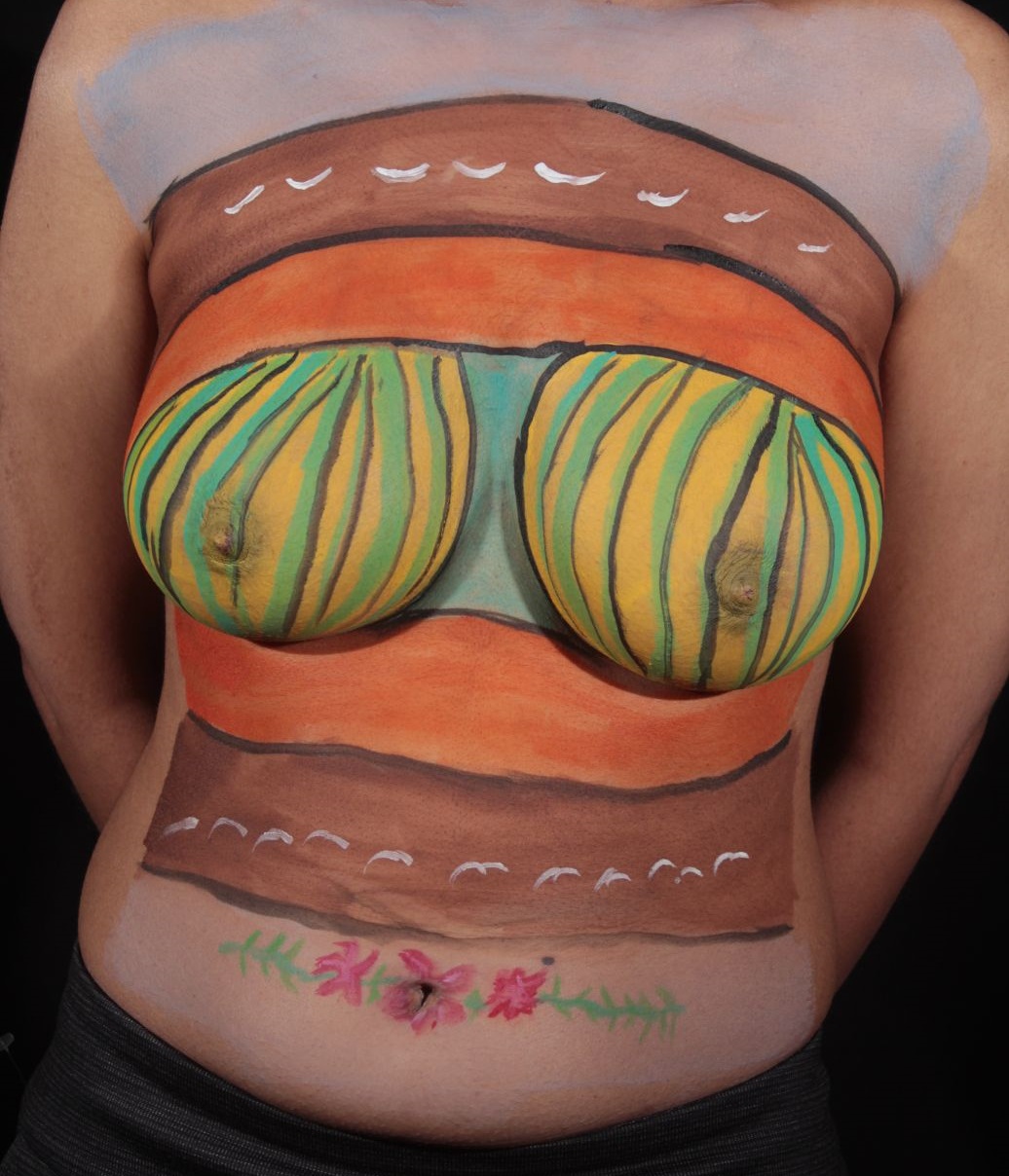 woman's breasts painted in green and yellow lines with brown and orange bands above and below