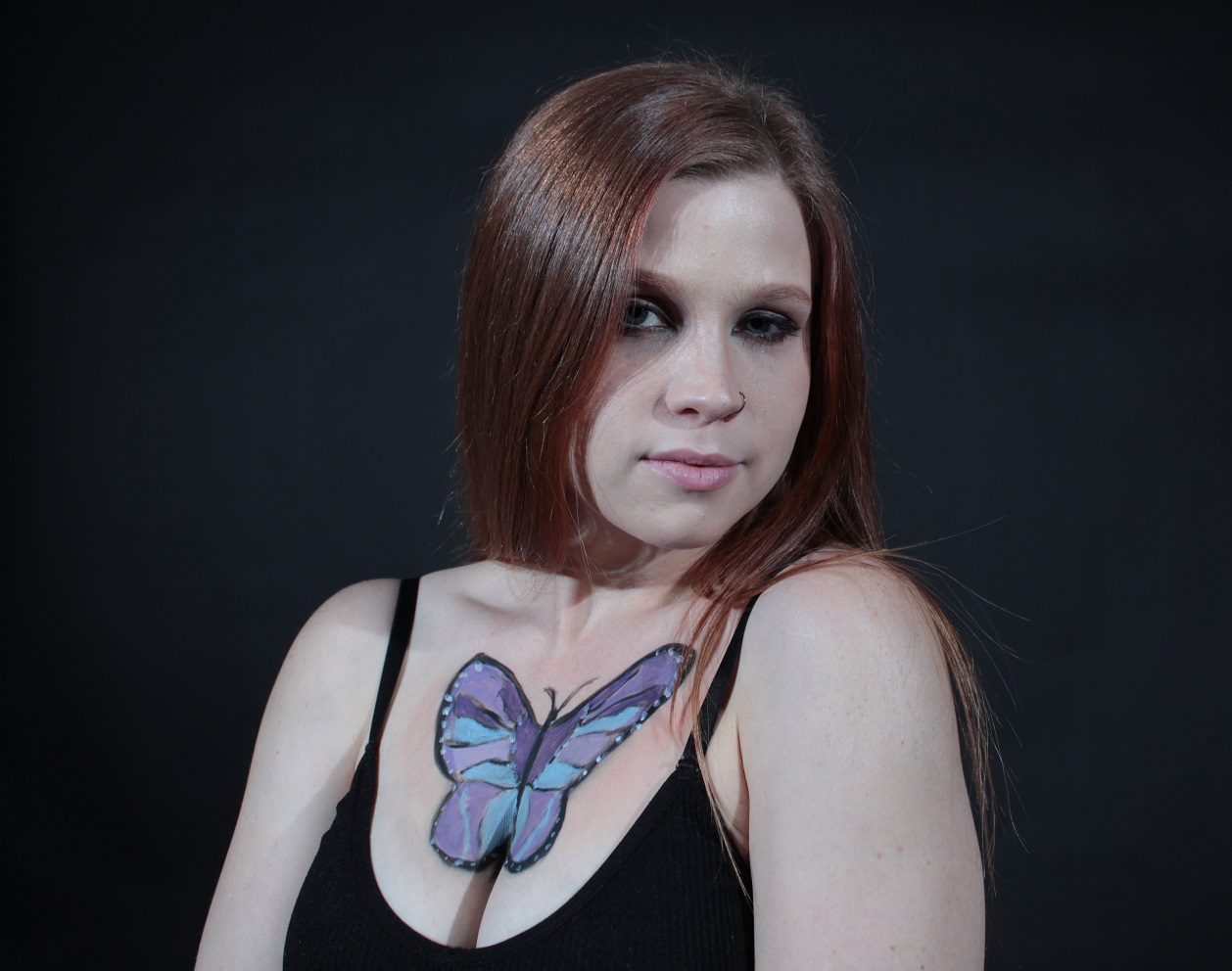 butterfly on woman's chest