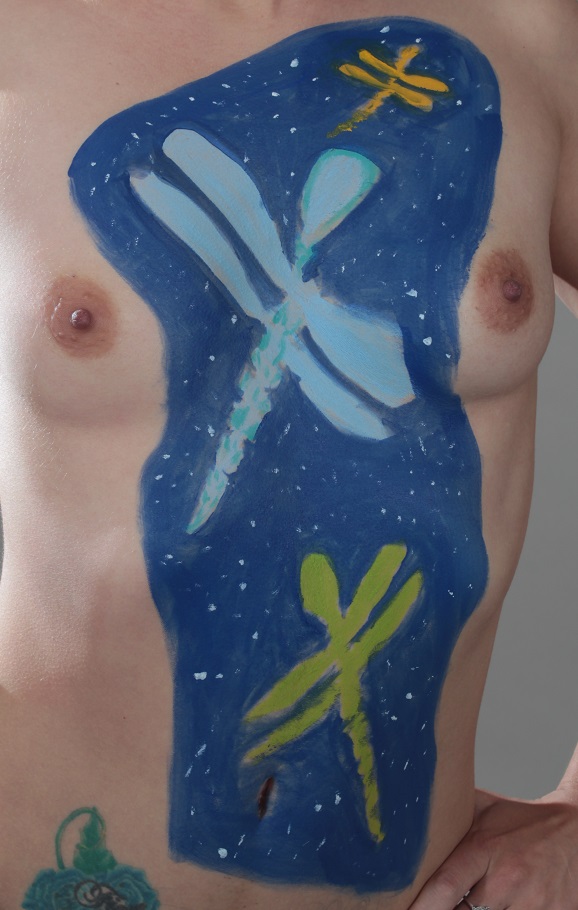 painting of dragonflies in the blue sky on woman's torso