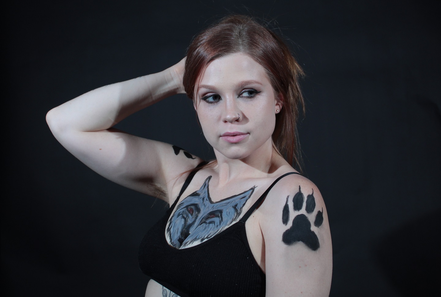 wolf face on woman's chest. Wolf paws on her shoulders