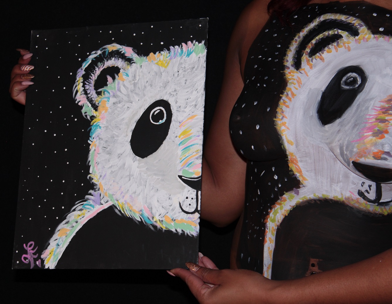 painting of panda on canvas next to copy on woman's torso