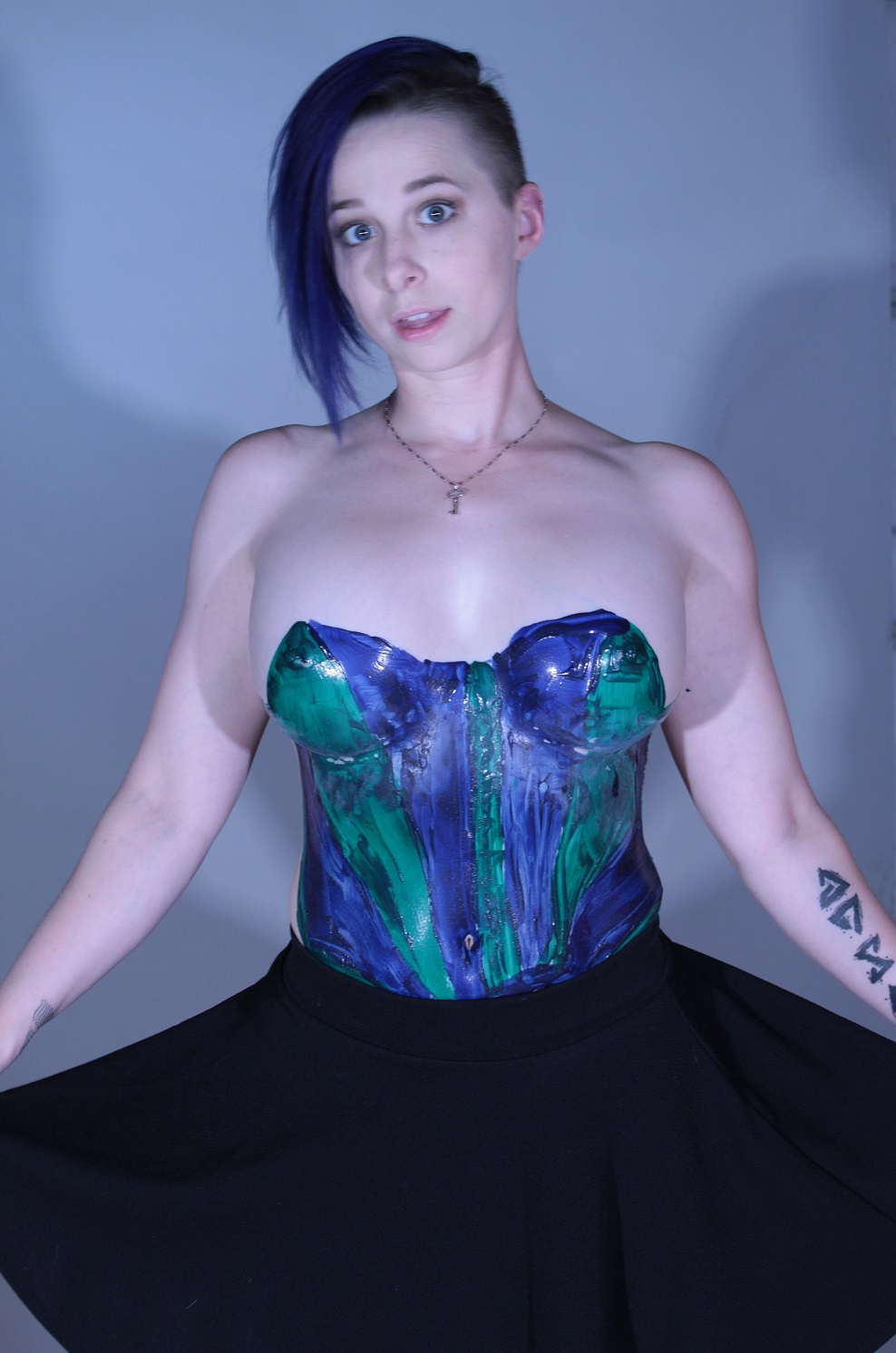 purple and green latex top on woman's torso