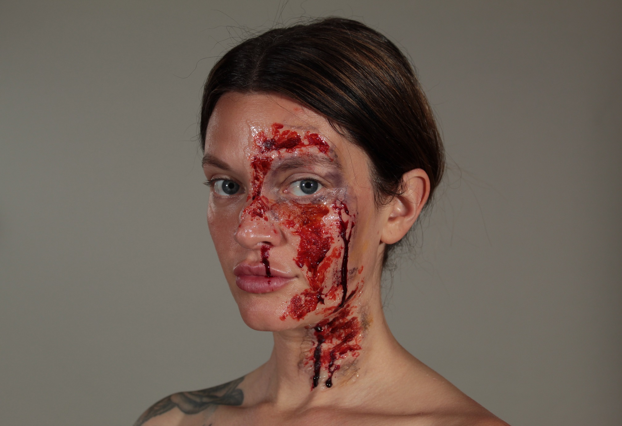 model stage blood and fake scars with bruising on her face