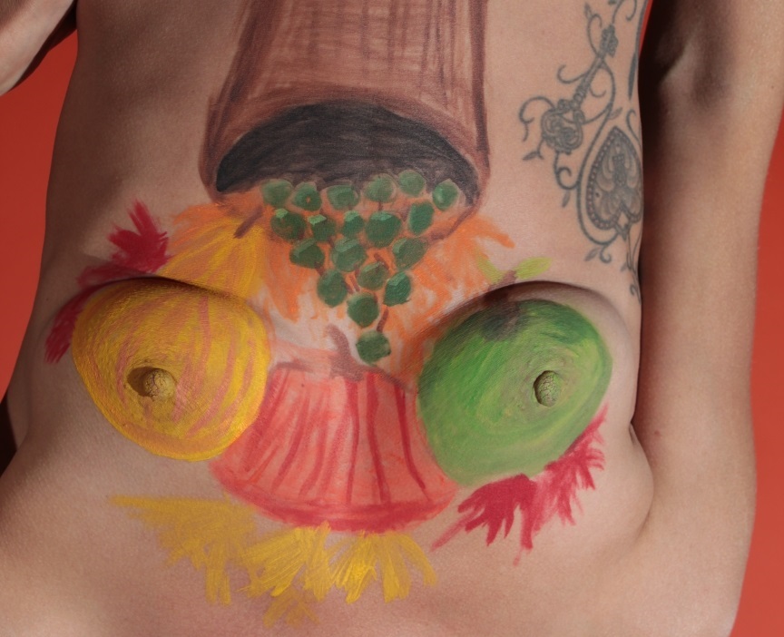 model Cornucopia painted between her breasts