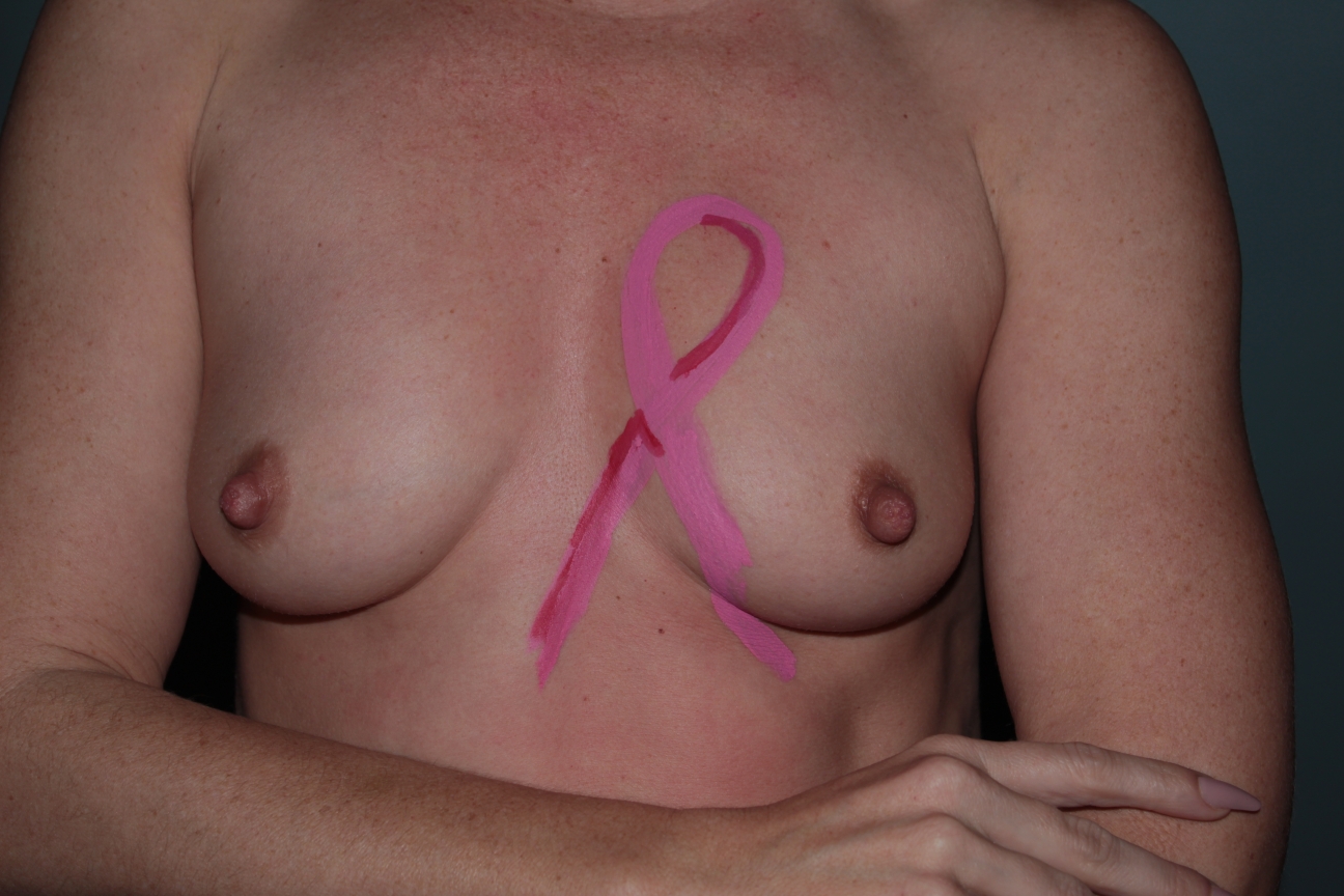 model with pink ribbon painted on her breast