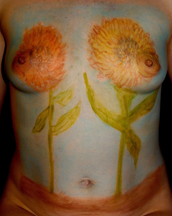 two flowers growing from dirt on woman's torso