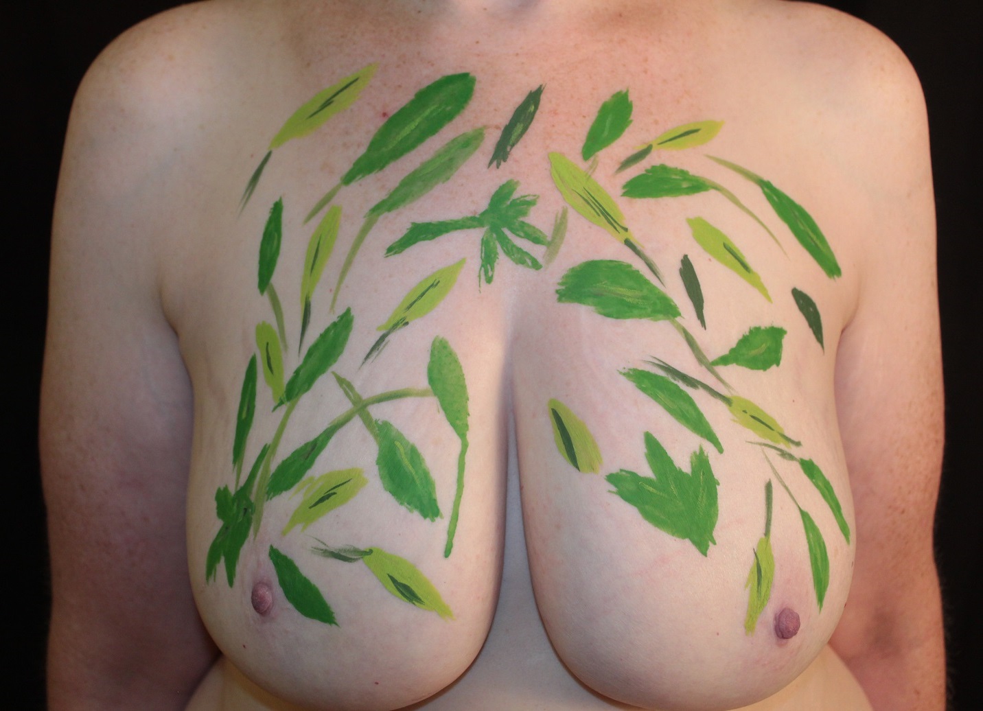 leaves on branches on woman's chest