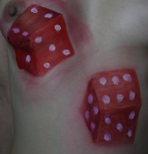 2 red dice painted on woman's breasts