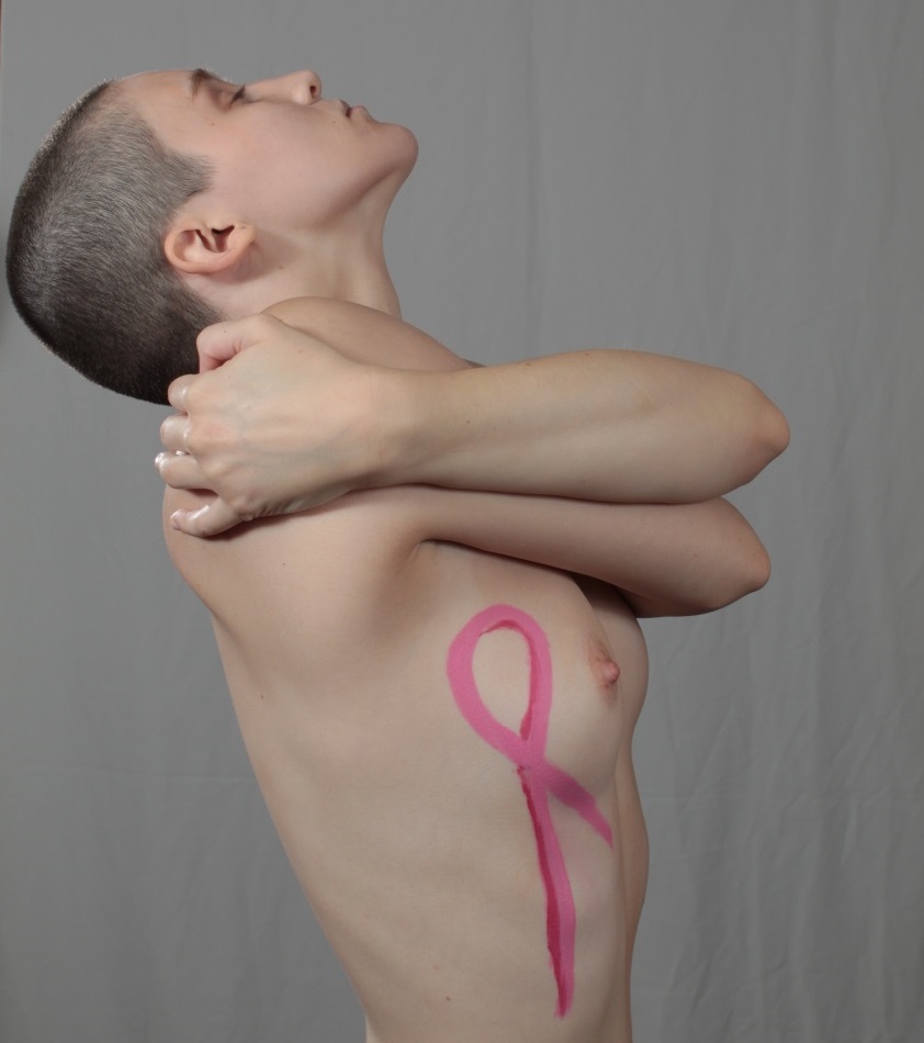body painting of pink ribbon on woman's chest