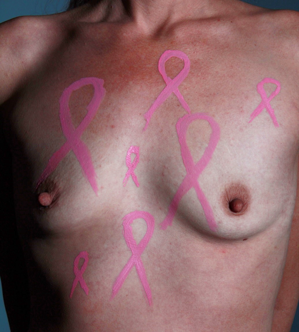 body painting of several pink ribbons on woman's chest