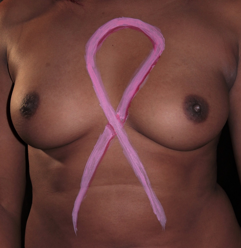 body painting of pink ribbon on woman's breast
