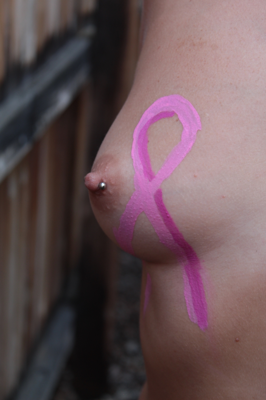 body painting of ribbon on woman's breast