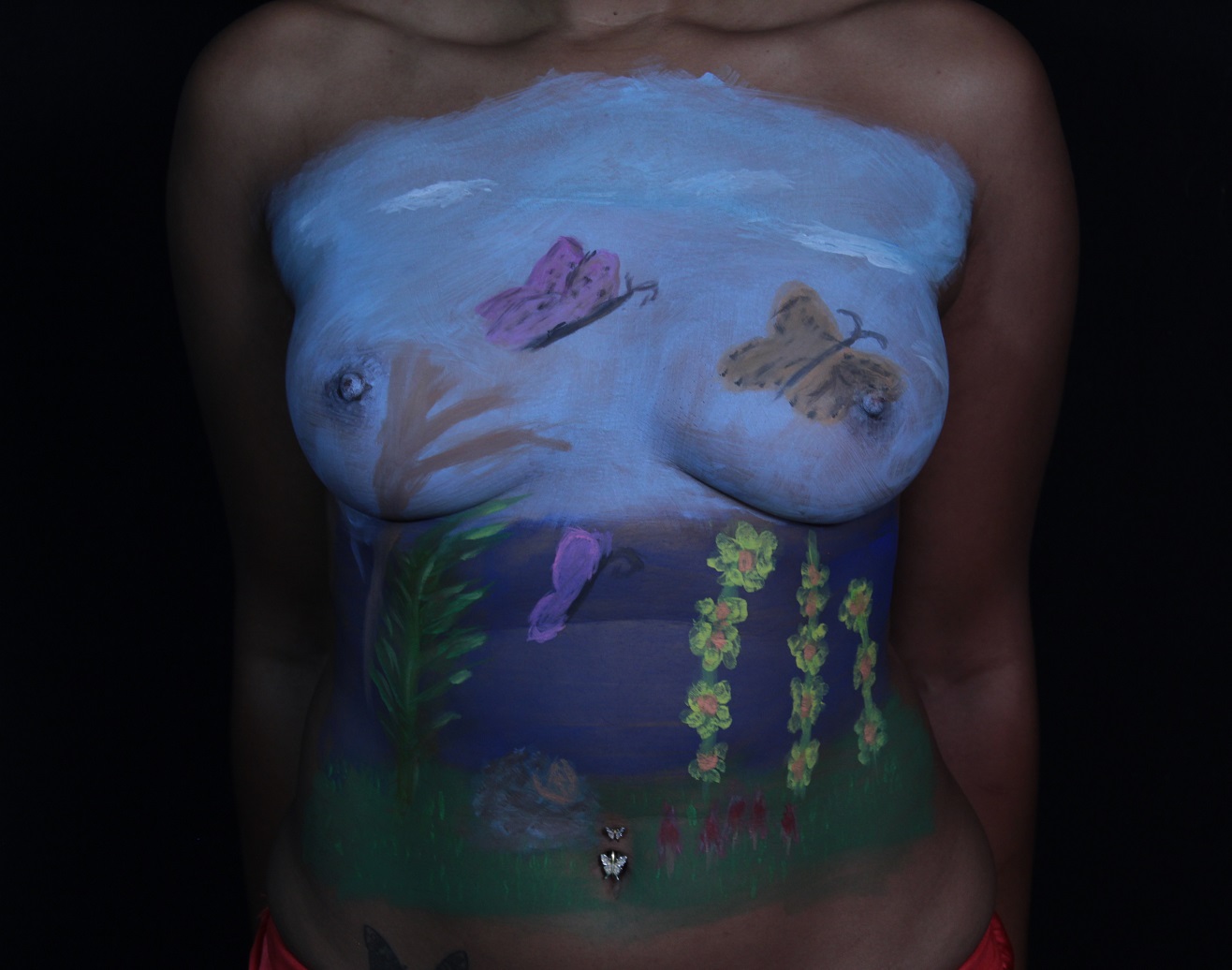 butterflies in a forest on woman's chest