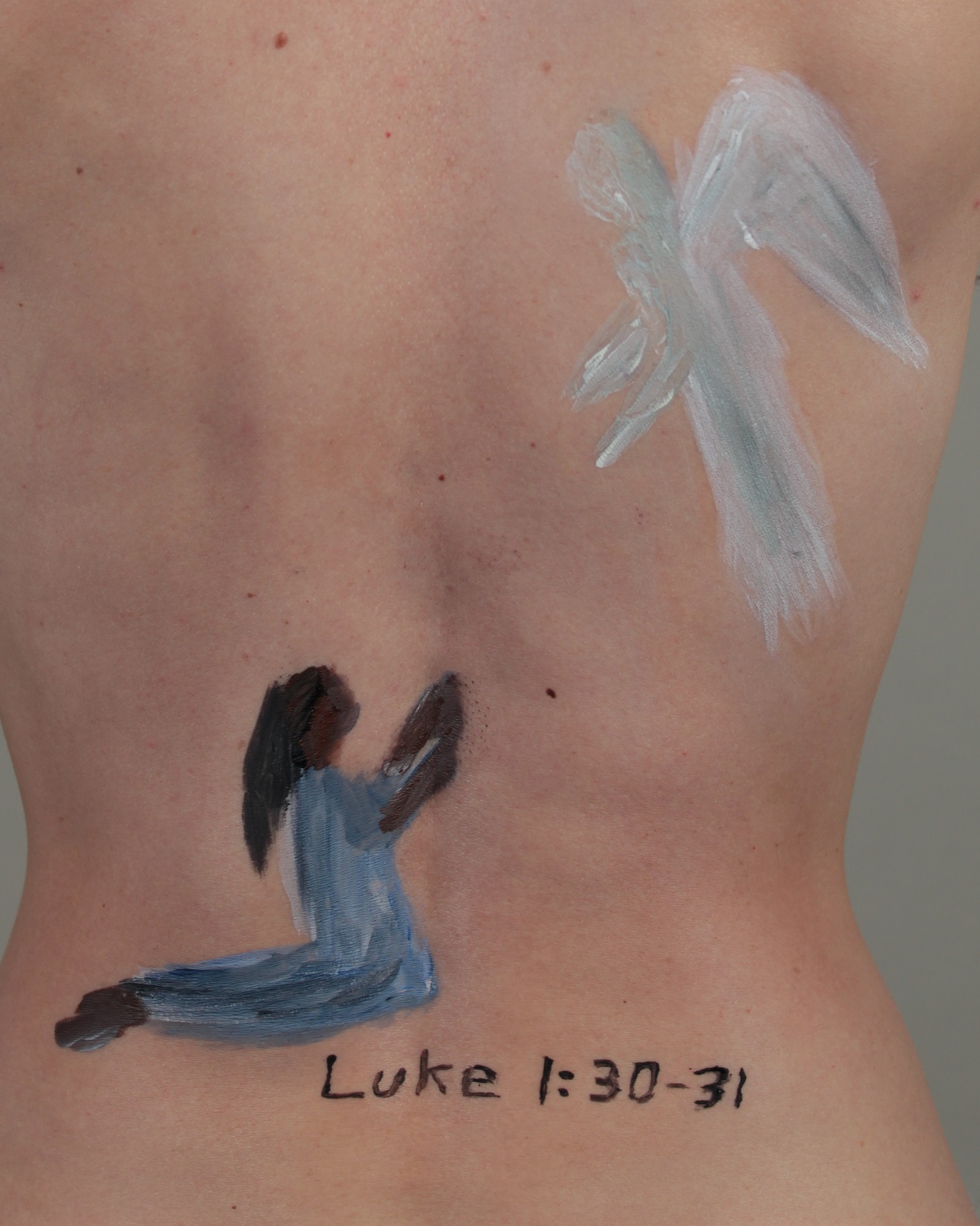 painting of The Angel speaking to Mary, painted on model's back