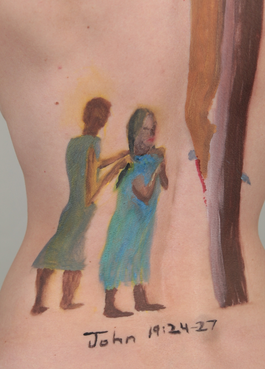 painting of John and Mary at the foot of Jesus on the cross painted on model's back