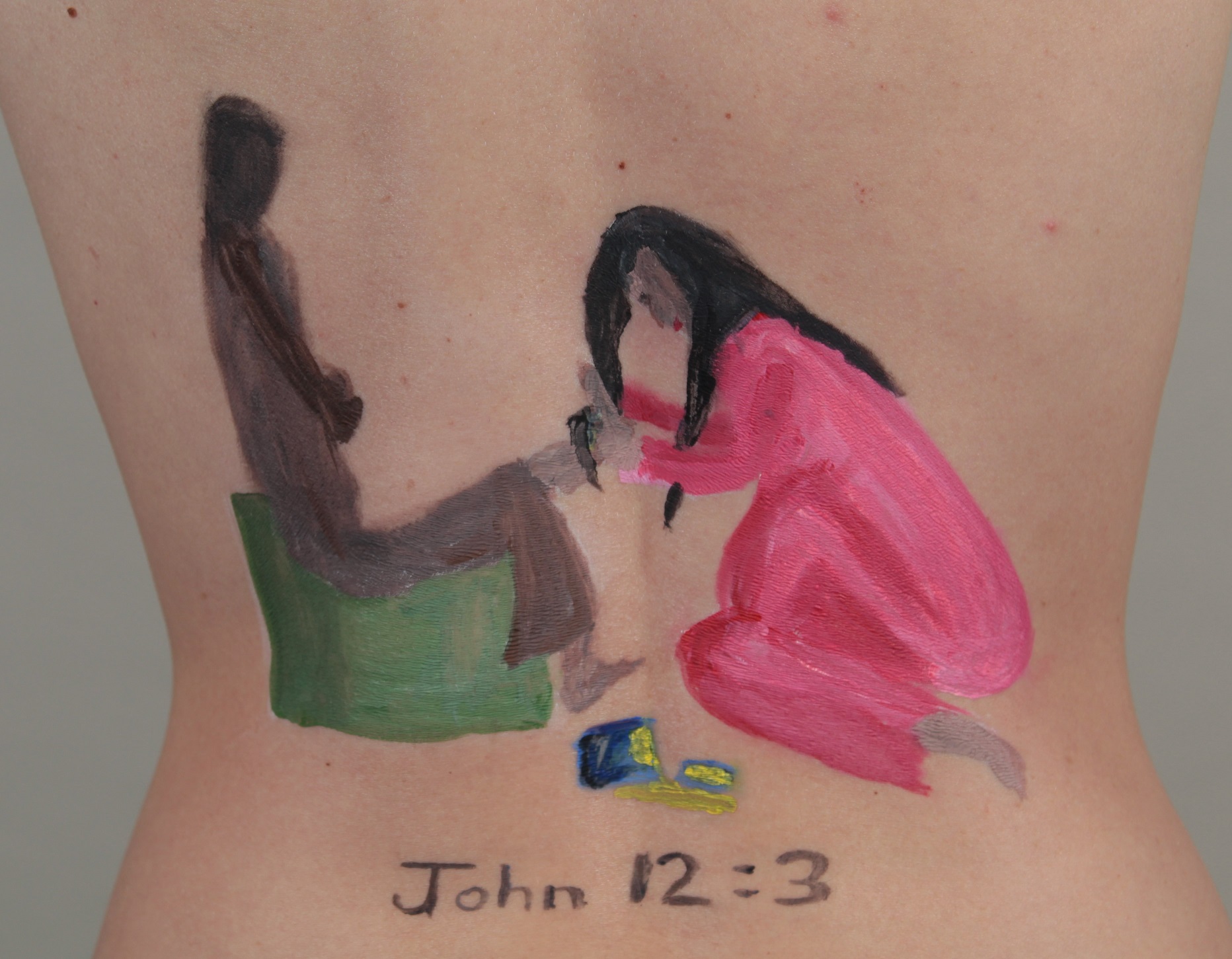 painting of Mary washing Jesus' feet, painted on model's back