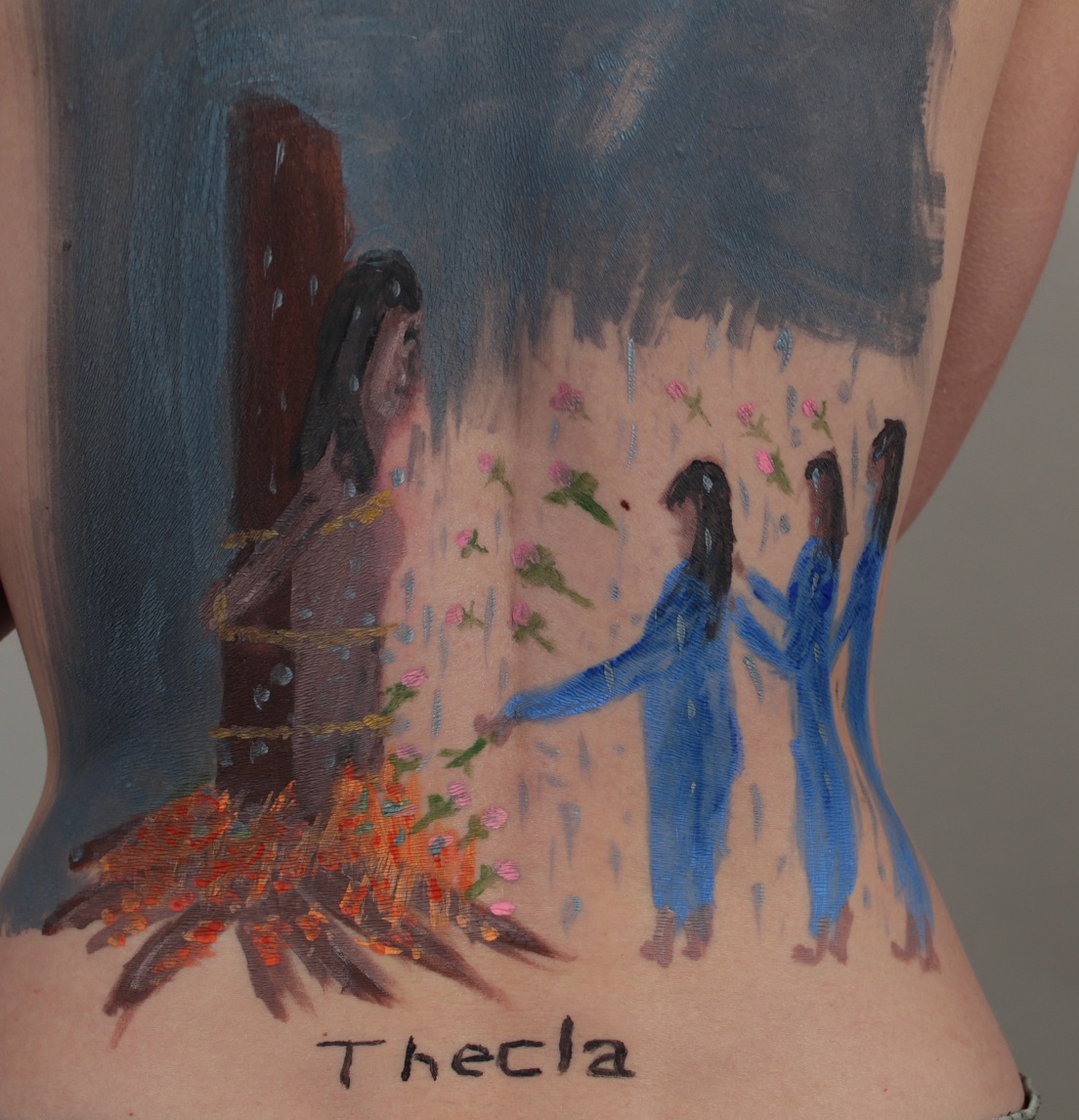 painting of Mary, Martha and Jesus on model's back