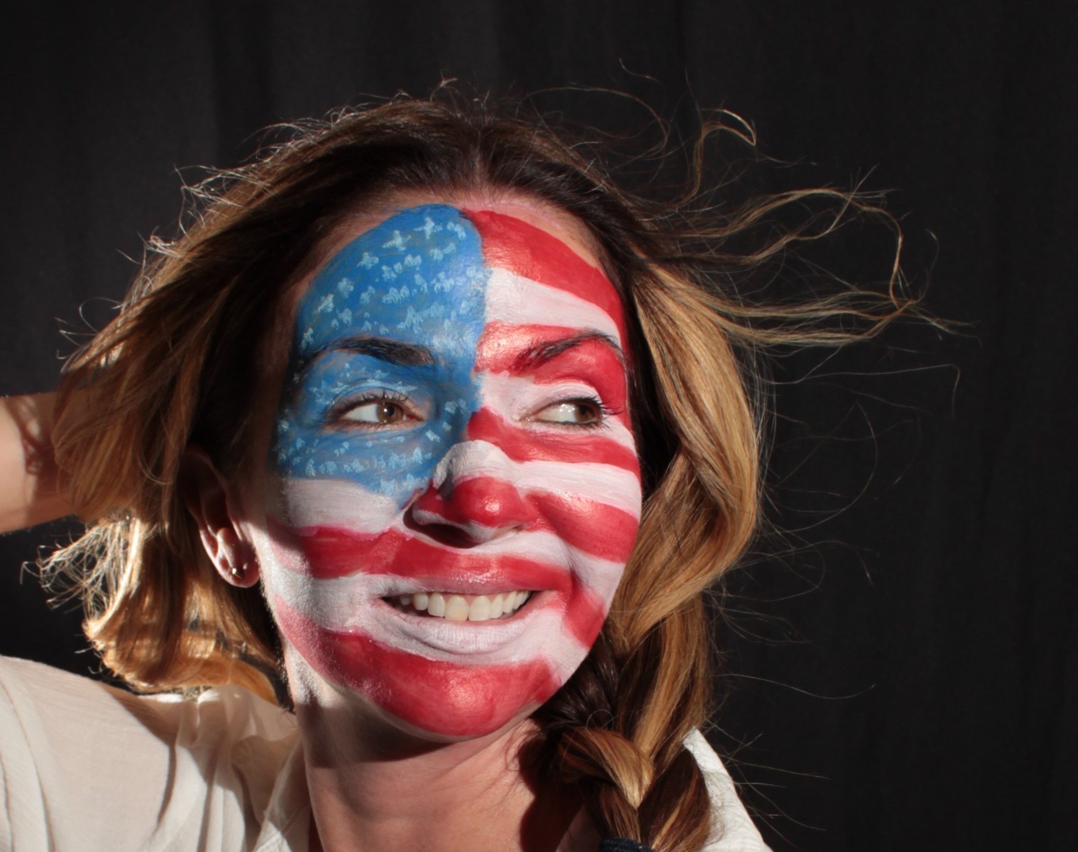 female face painted with an American flag