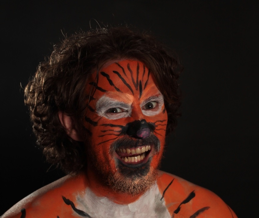 male face painted as orange tiger