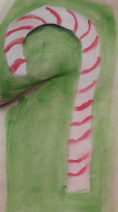 model with candy cane painted on side of her breast and chest