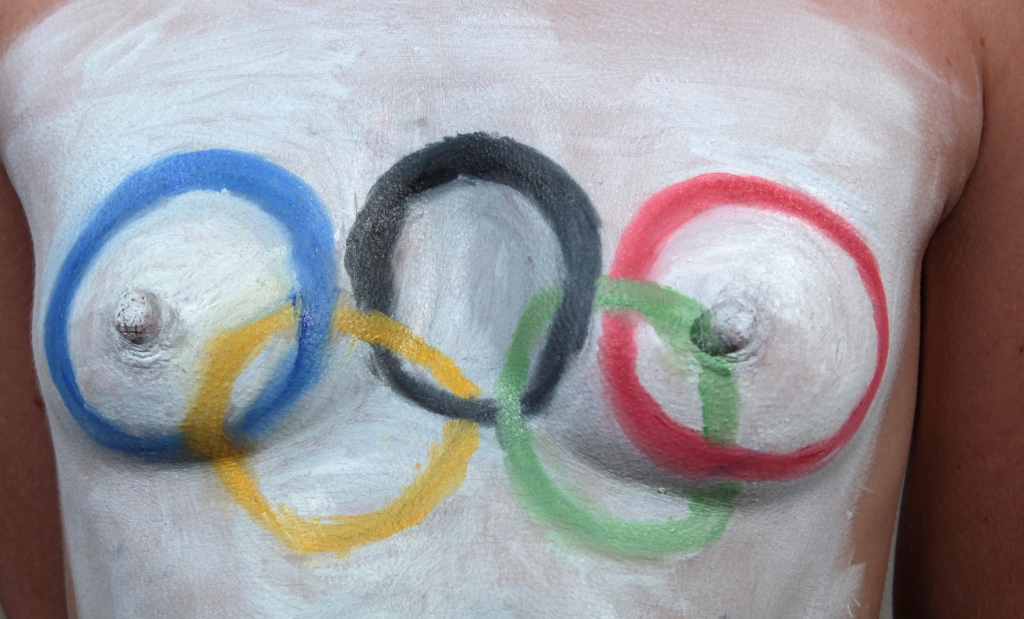 model with Olympic Rings painted across her breasts