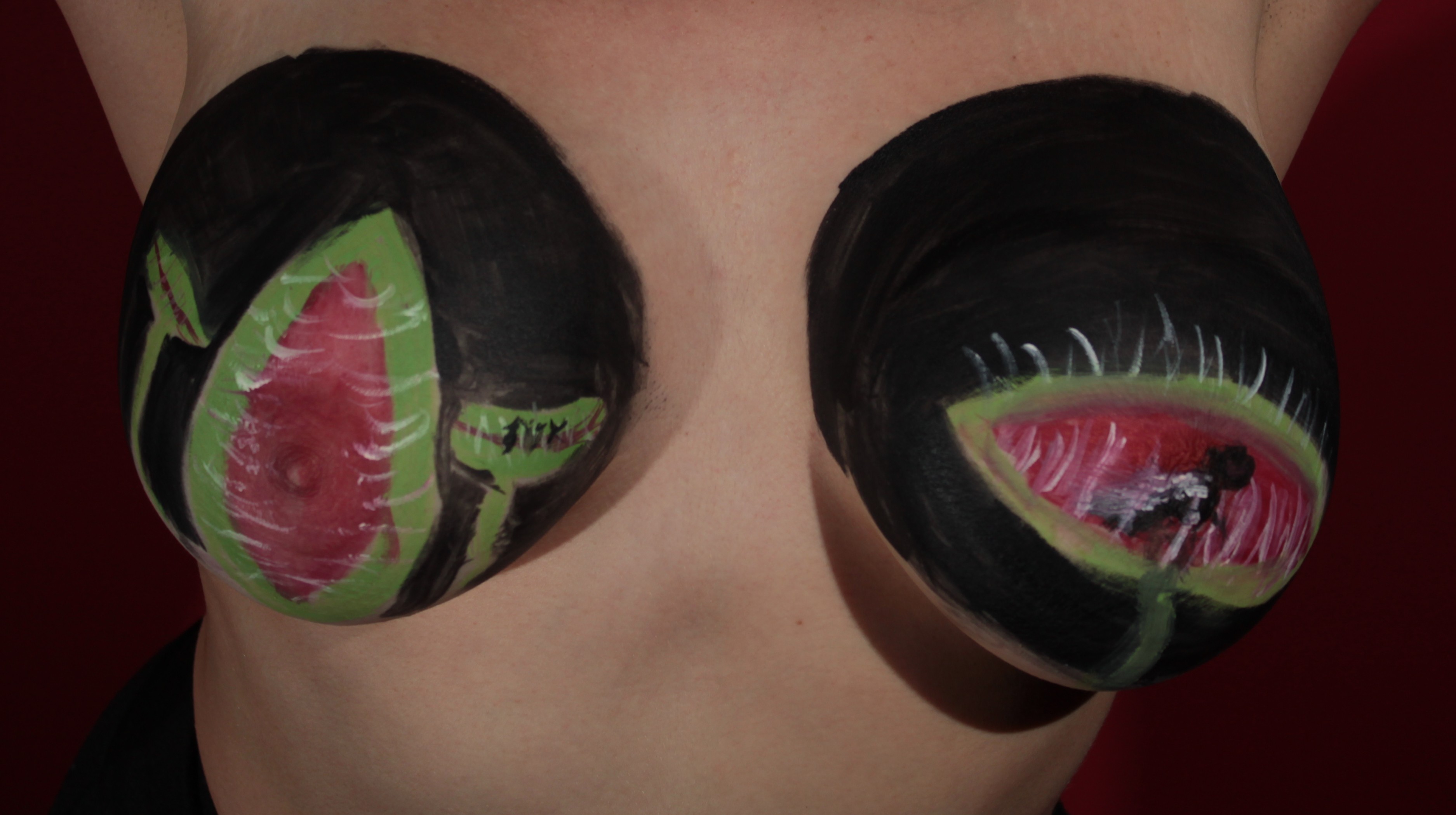 female torso painted with a venus fly trap on each breast