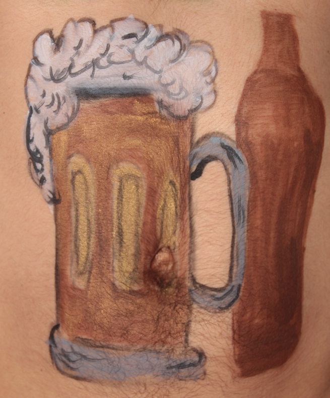 mug of beer, with a foam head, in front of a bottle of beer painted on male torso