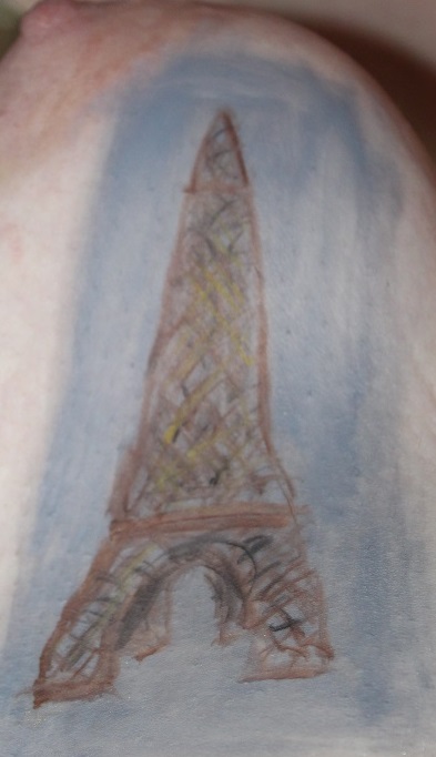 Eiffel tower painted on woman's breast