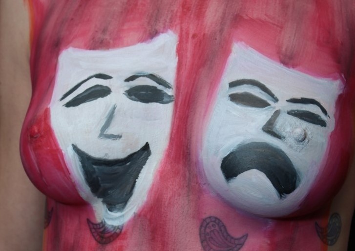 Theater Comedy & Tragedy masks painted upon woman's torso