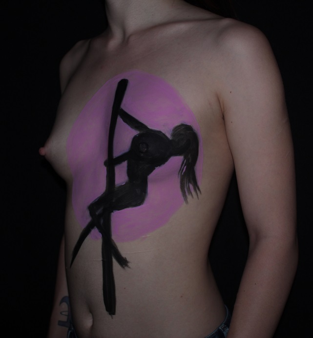 painting of silhouette woman pole dancing painted on woman's chest