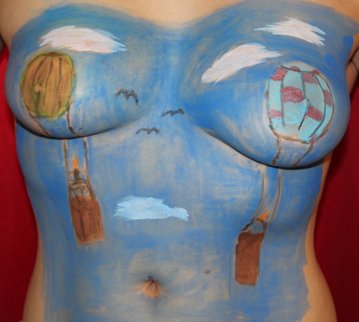 hot air balloons painted on woman's breasts