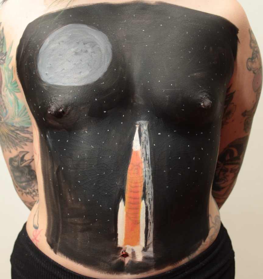rocket on launch pad with moon above on female torso